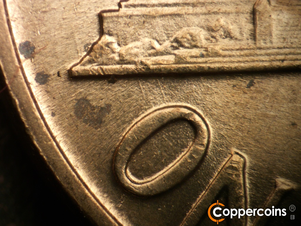 Die-stage C marker on 1960D•1MM•183 showing NNW die scratch from left base is still visible. SSE die scratch from base to O in ONE is still strong.