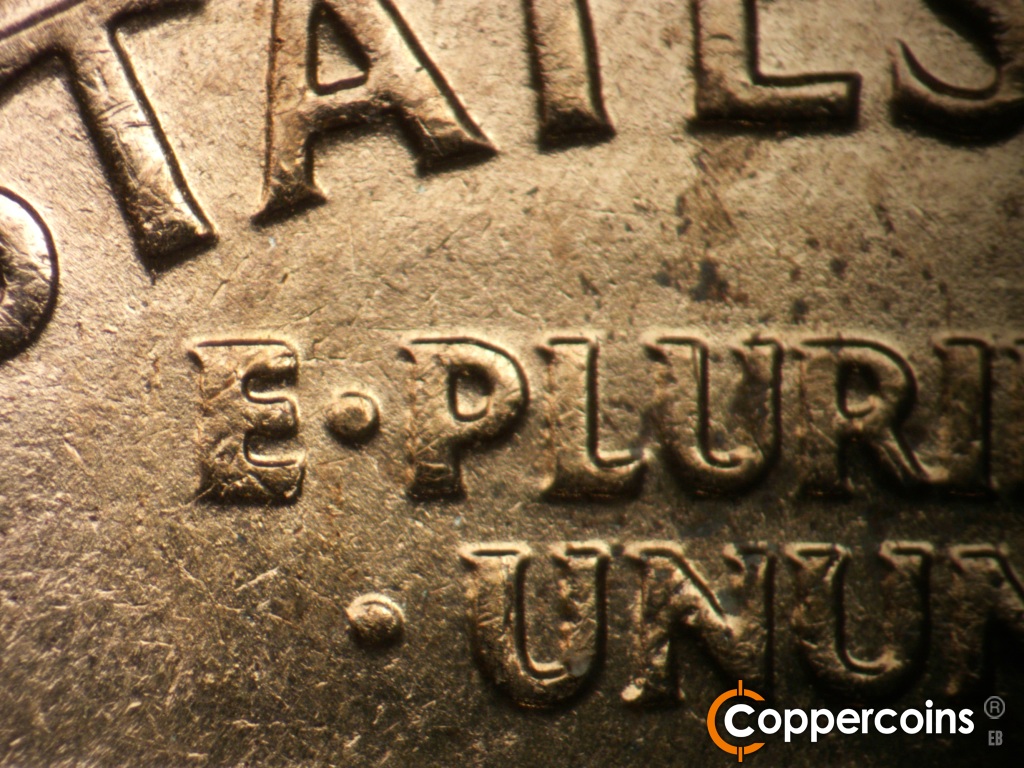 Die-stage C marker on 1960D•1MM•183 showing Light die scratch above E in E PLURIBUS.