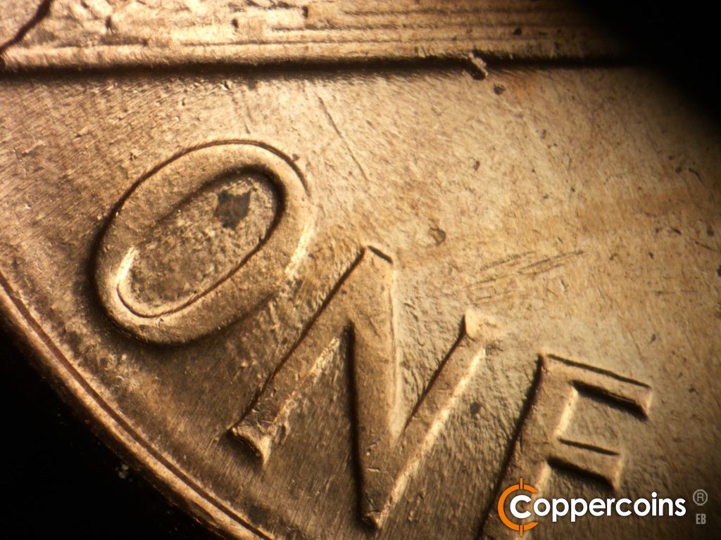 Die-stage B marker on 1960D•1MM•200 showing SSE die scratches from base through ONE.