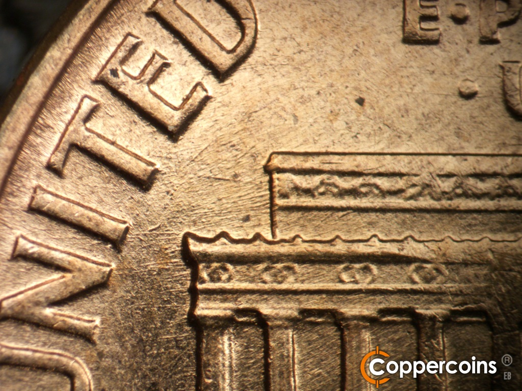 Die-stage B marker on 1960D•1MM•295 showing Generally E/W die scratches from left roof/cornice toward IT in UNITED.