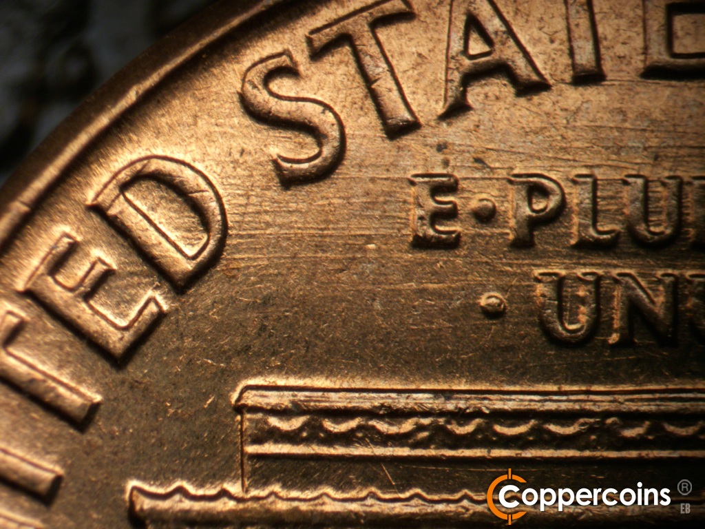 Die-stage C marker on 1960D•1MM•296 showing E/W die scratches from ED in UNITED into E PLURIBUS UNUM.