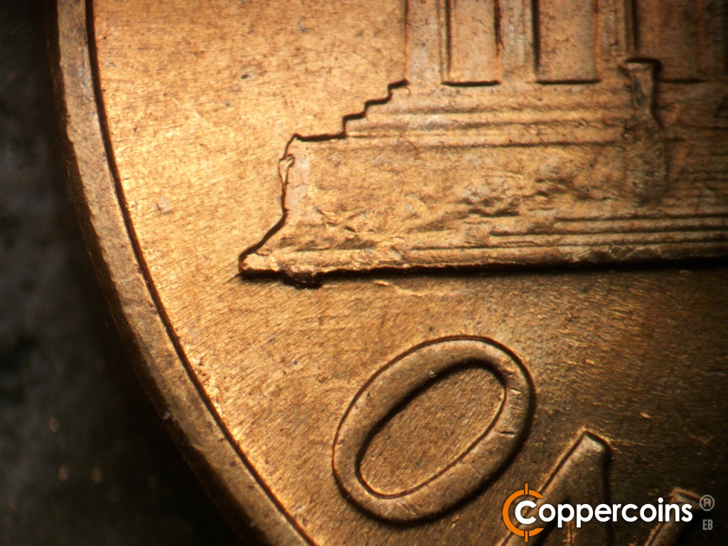 Die-stage C marker on 1960D•1MM•296 showing Die chipping on left base.