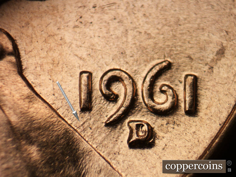 Die-stage C marker on 1961D•1MM•021 showing SW die scratches from 9 in date to lapel.