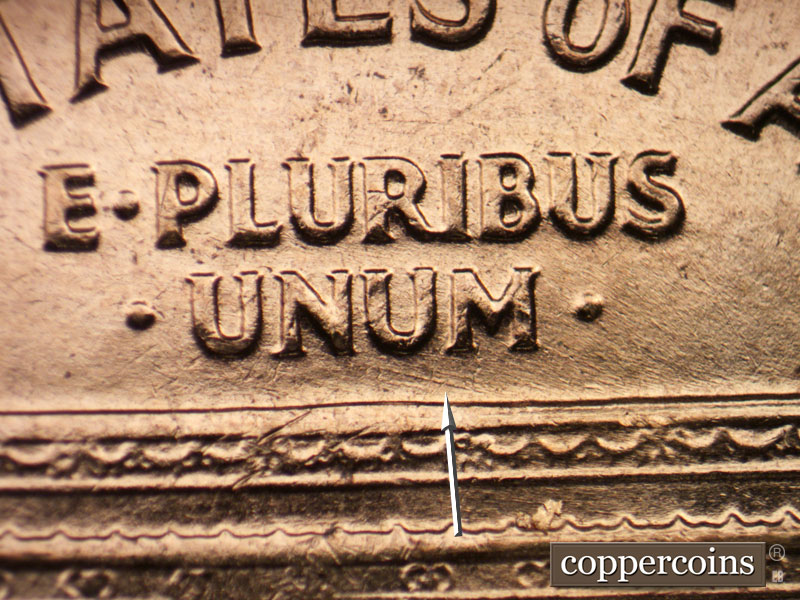 Die-stage C marker on 1961D•1MM•021 showing Light ESE die scratches under UNUM.