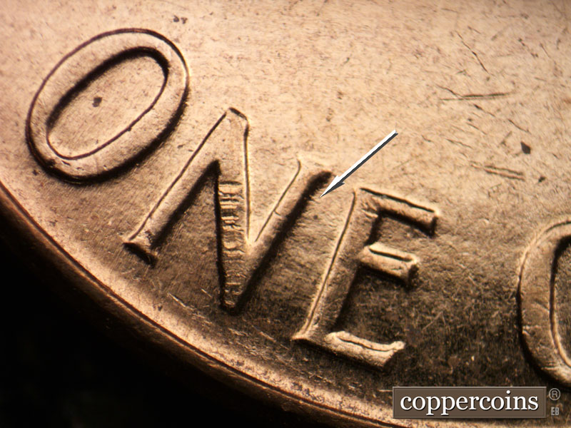 Die-stage C marker on 1961D•1MM•021 showing Short die scratch from N in ONE.