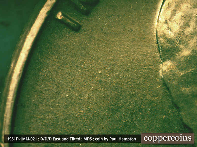 Die-stage A marker on 1961D•1MM•021 showing A heavy die dot shows in the middle of the field behind the head.