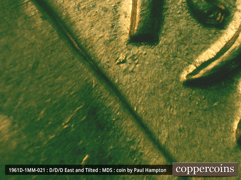 Die-stage A marker on 1961D•1MM•021 showing Die damage shows as a mottled area under the 1 of the date.