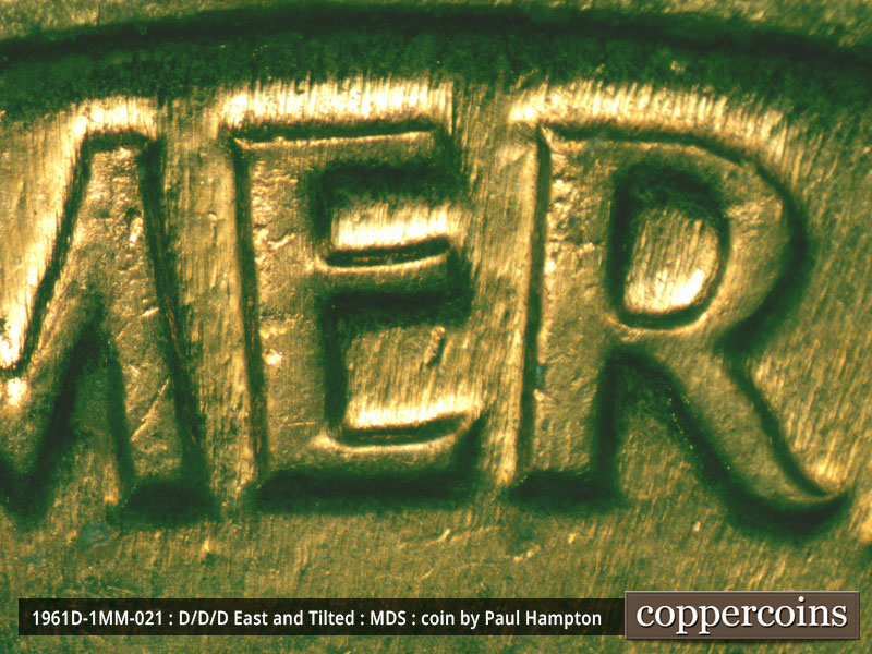 Die-stage A marker on 1961D•1MM•021 showing A die dot shows inside the lower E of AMERICA.