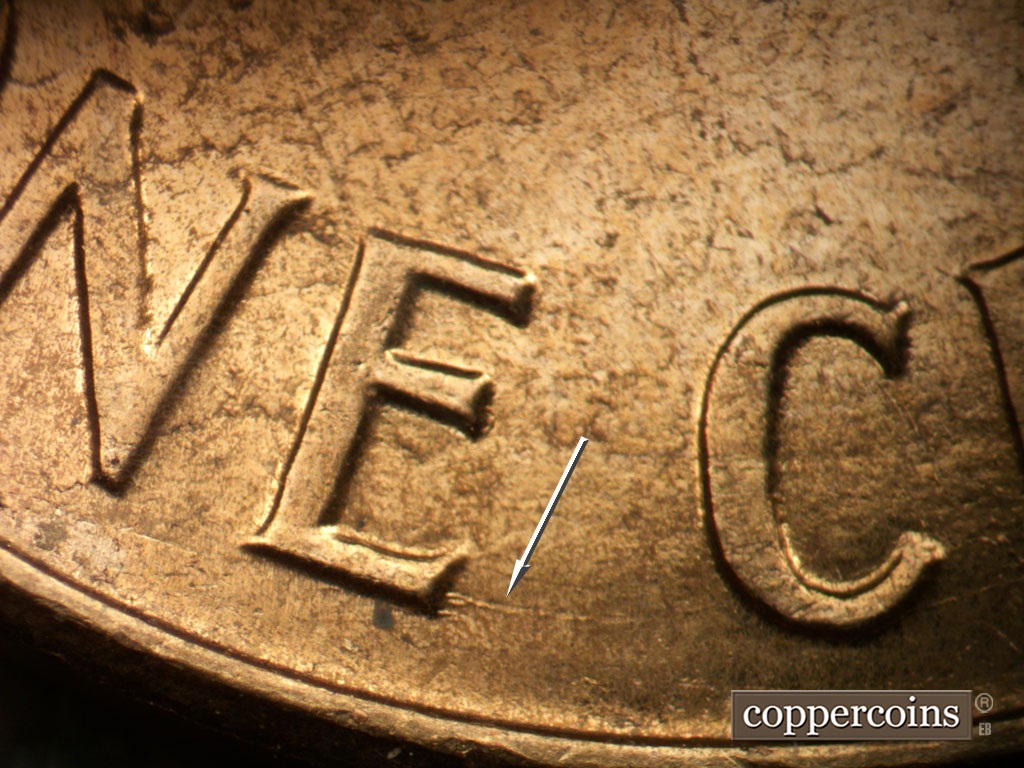 Die-stage B marker on 1961D•1MM•035 showing Concentric scratch from bottom of E in ONE.