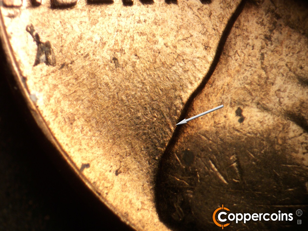 Die-stage C marker on 1961D•1MM•047 showing NW die gouge from back of shoulder.