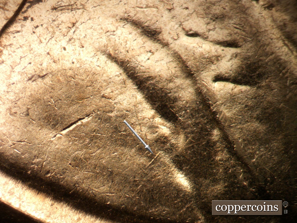 Die-stage C marker on 1961D•1MM•048 showing SW die scratch on front of shoulder.
