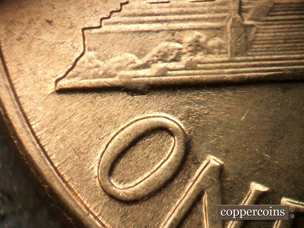 Die-stage C marker on 1961D•1MM•048 showing Die chip on base to the left side.