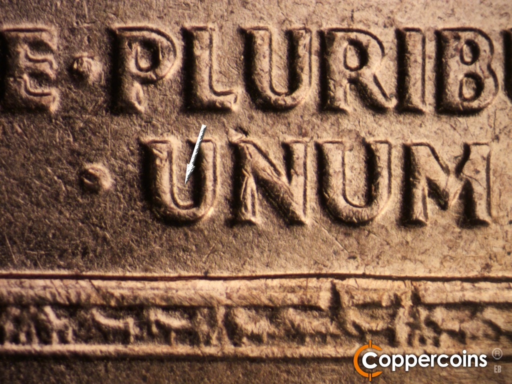 Die-stage C marker on 1961D•1MM•060 showing Small die scratch in first U in UNUM.