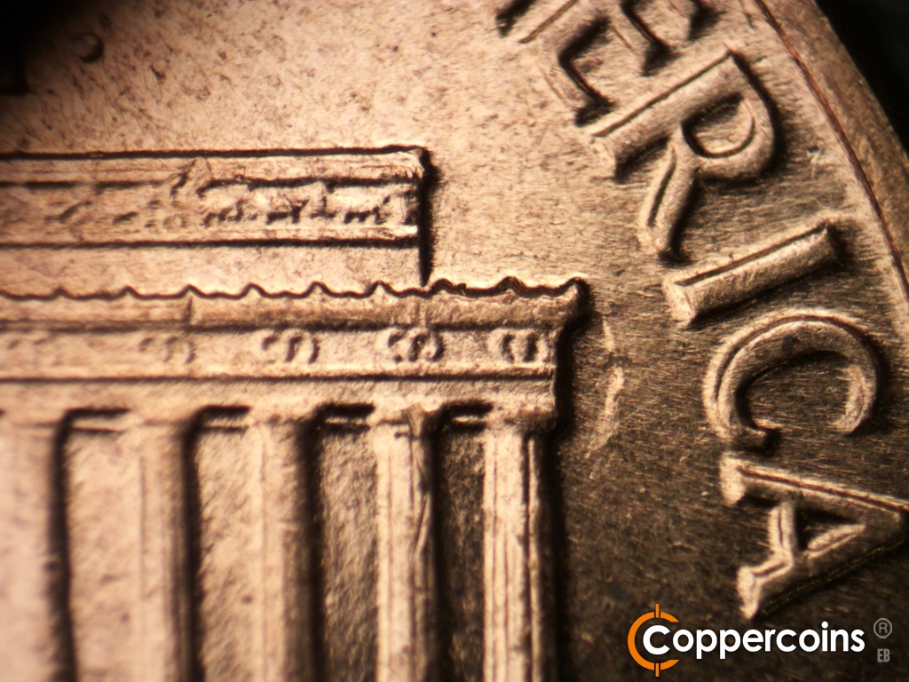 Die-stage C marker on 1961D•1MM•060 showing Die depression next to right cornice.