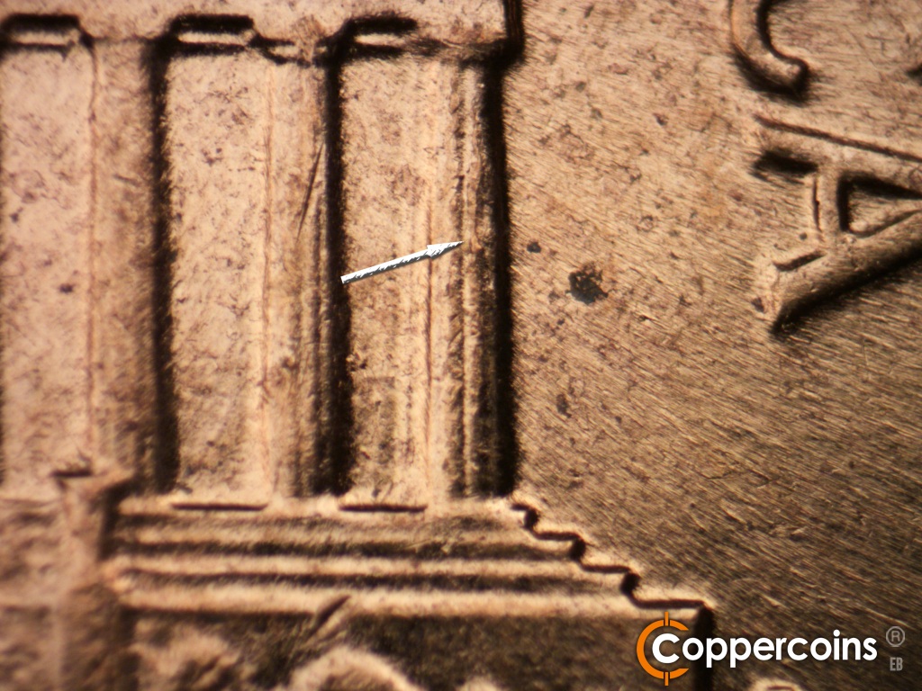 Die-stage C marker on 1961D•1MM•060 showing Die crack on upper part of column 12.