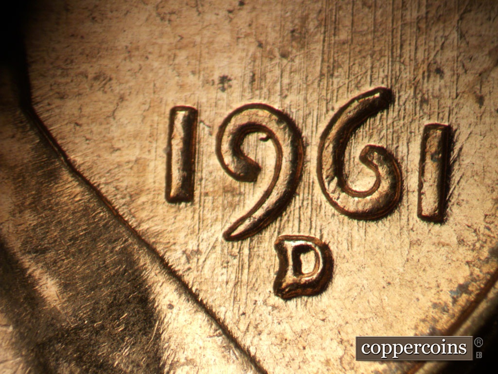 Die-stage B marker on 1961D•1MM•072 showing N/S die scratches through date.