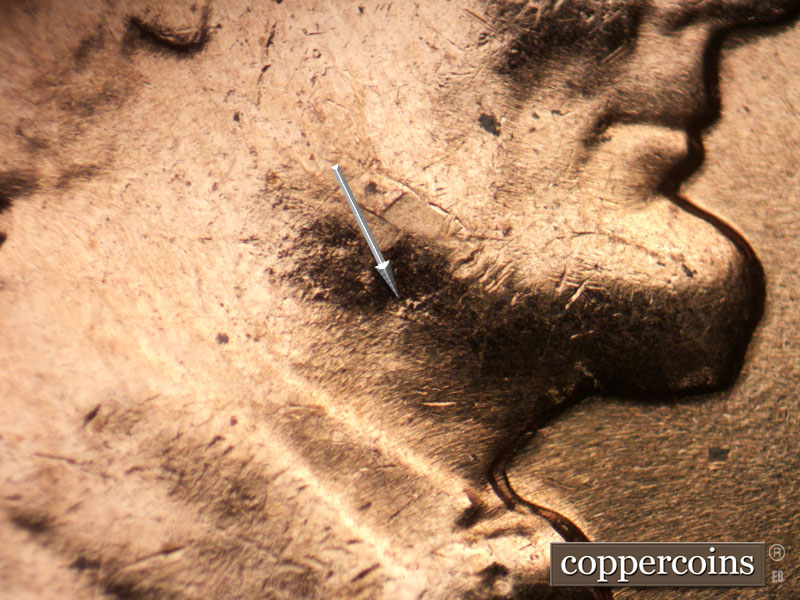 Die-stage B marker on 1961D•1MM•127 showing Die pitting on neck.