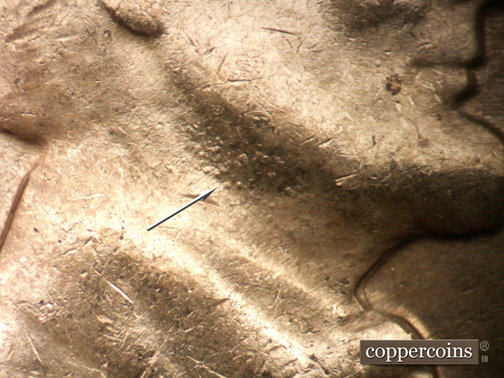 Die-stage C marker on 1961D•1MM•127 showing Die pitting on neck.