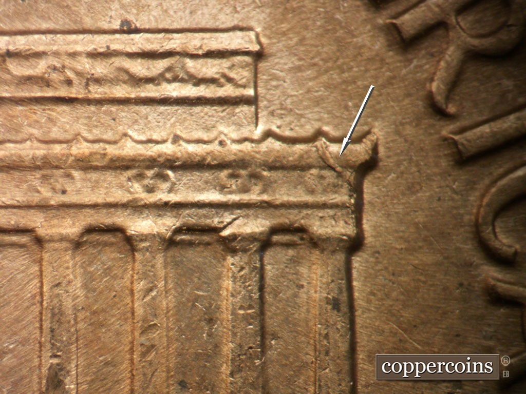Die-stage C marker on 1961D•1MM•127 showing Die chipping seen on left cornice.