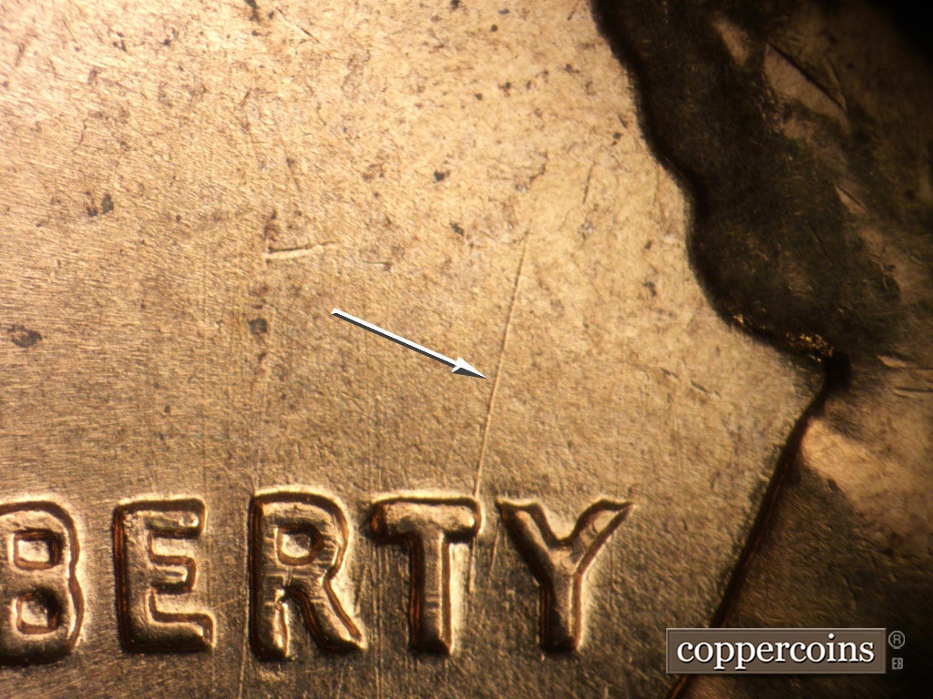 Die-stage B marker on 1961D•1MM•135 showing NNE die scratch from top of T in LIBERTY.
