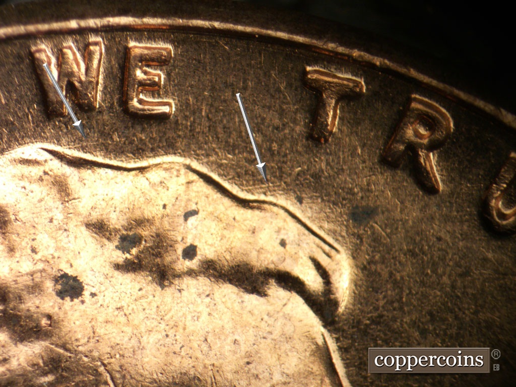 Die-stage B marker on 1961D•1MM•135 showing Weak ENE die scratches visible under WE and TRUST.