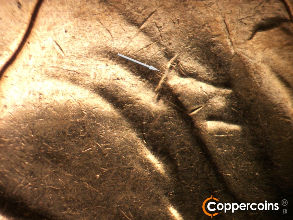 Die-stage C marker on 1961D•1MM•139 showing Die gouge in jacket into lapel.