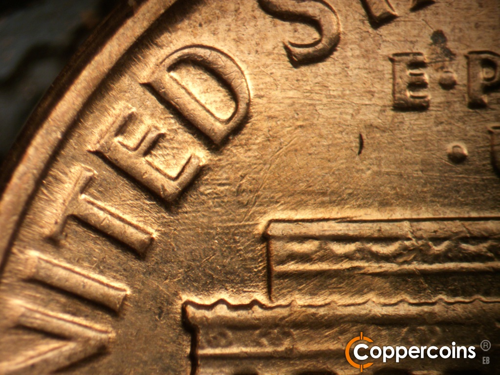 Die-stage C marker on 1961D•1MM•139 showing E/W die scratches from left roof to TED in UNITED.