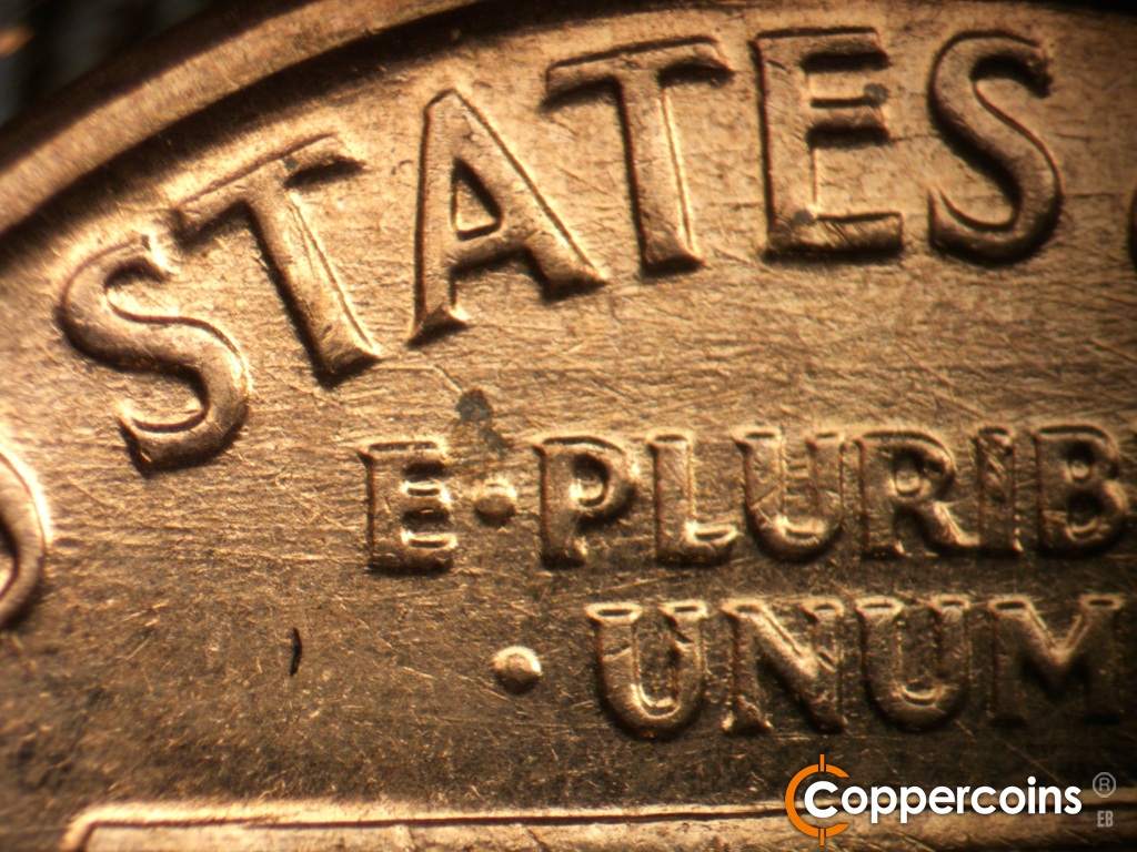 Die-stage C marker on 1961D•1MM•139 showing E/W die scratches through and above E PLURIBUS UNUM.