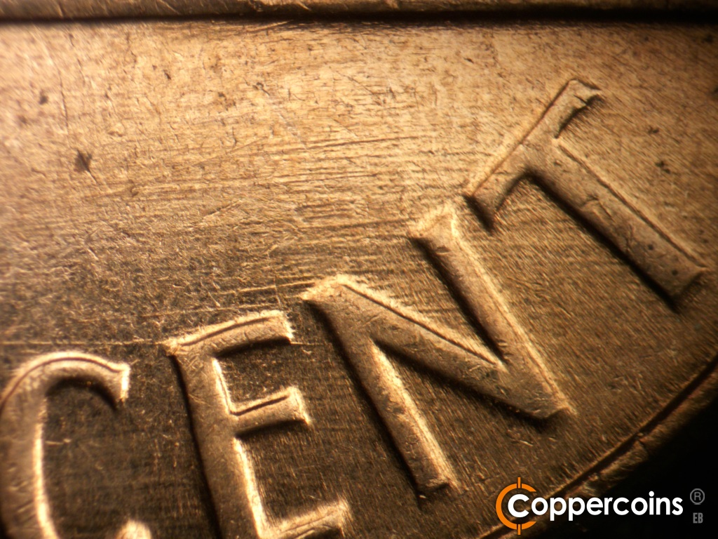Die-stage C marker on 1961D•1MM•139 showing E/W die scratches through CENT.