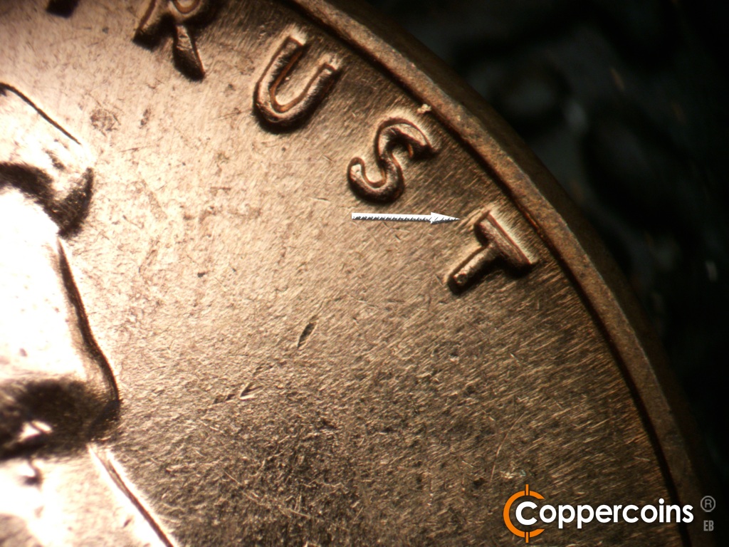 Die-stage B marker on 1961D•1MM•140 showing Die gouge near top of last T in TRUST.