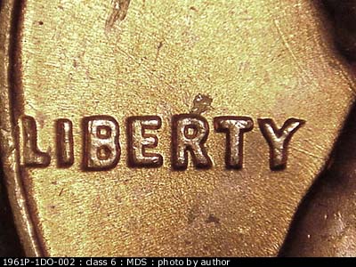 Die-stage B marker on 1961P•1DO•002 (1961 Doubled Die Obverse).