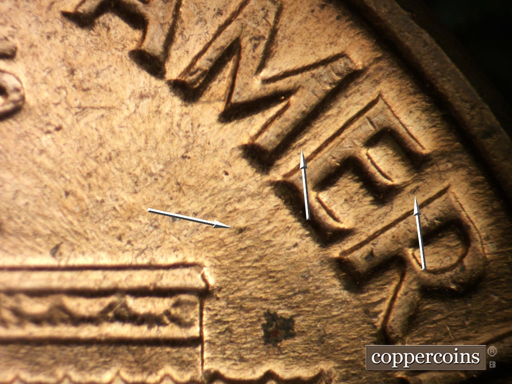 Die-stage B marker on 1962D•1DO•006 showing Die dot under E in AMERICA.Heavy die flow shows between MER in AMERICA.