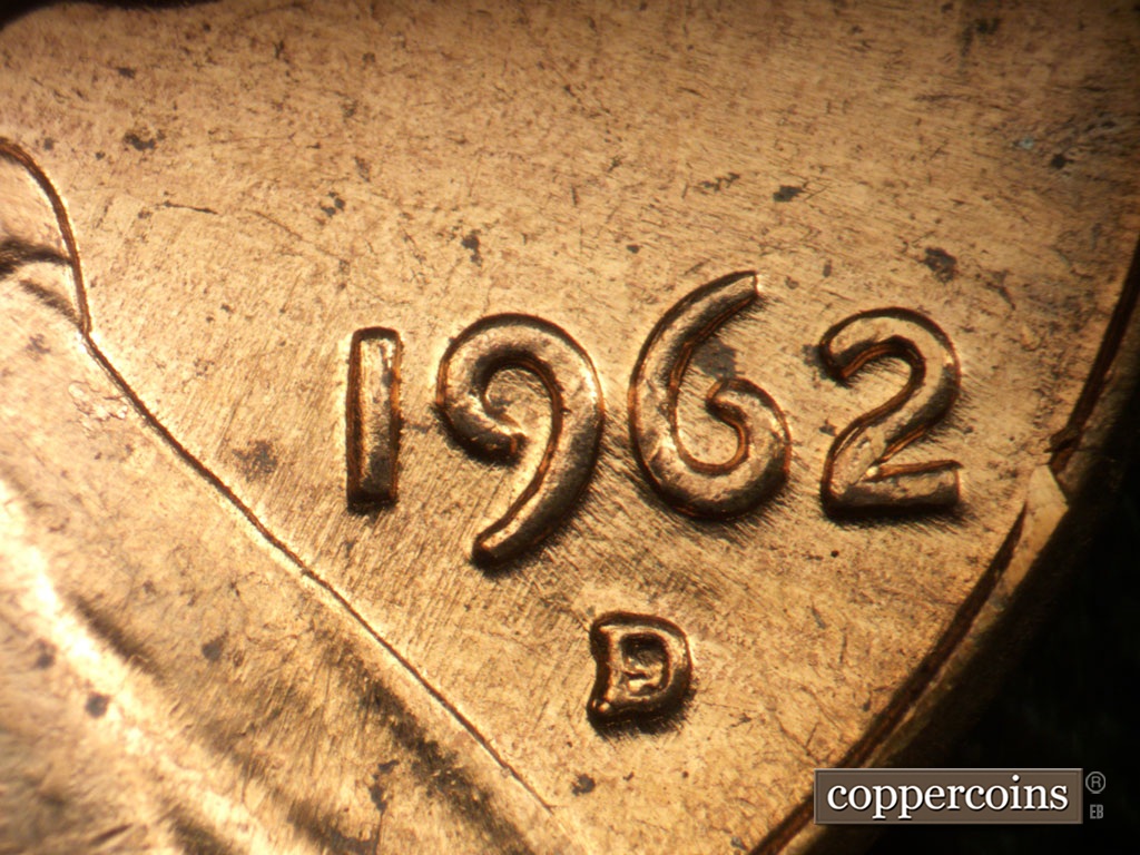 Die-stage A marker on 1962D•1MM•008 showing NNE die scratches from lapel into 19 of date.