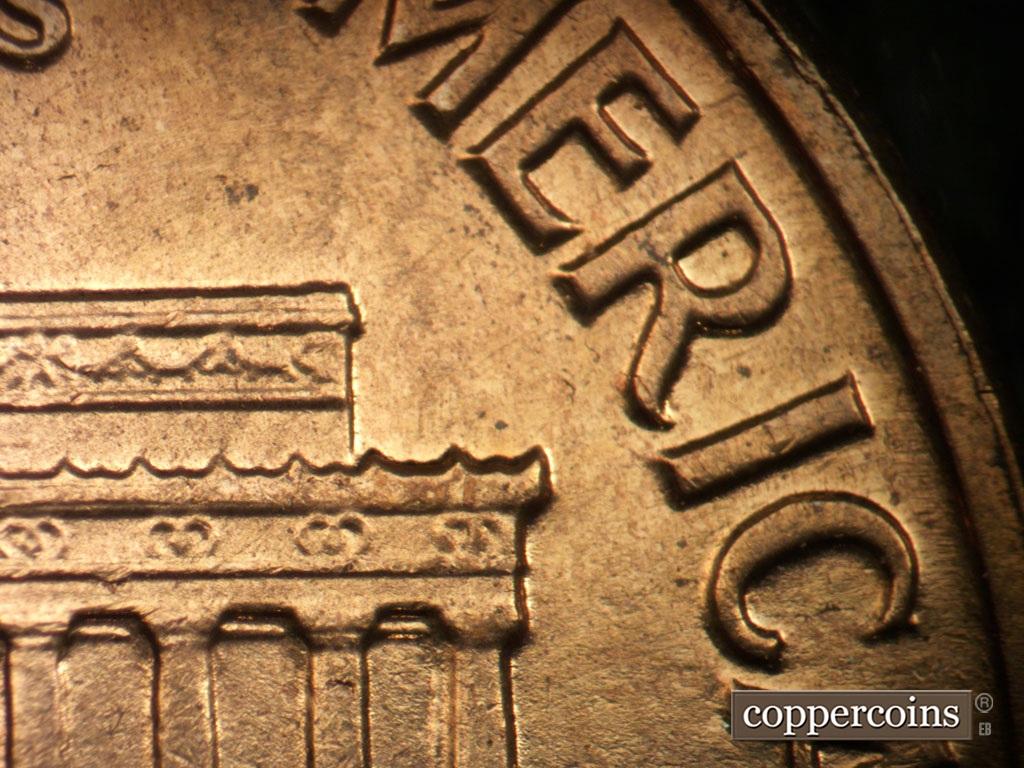 Die-stage A marker on 1962D•1MM•008 showing No die chip in right cornice.