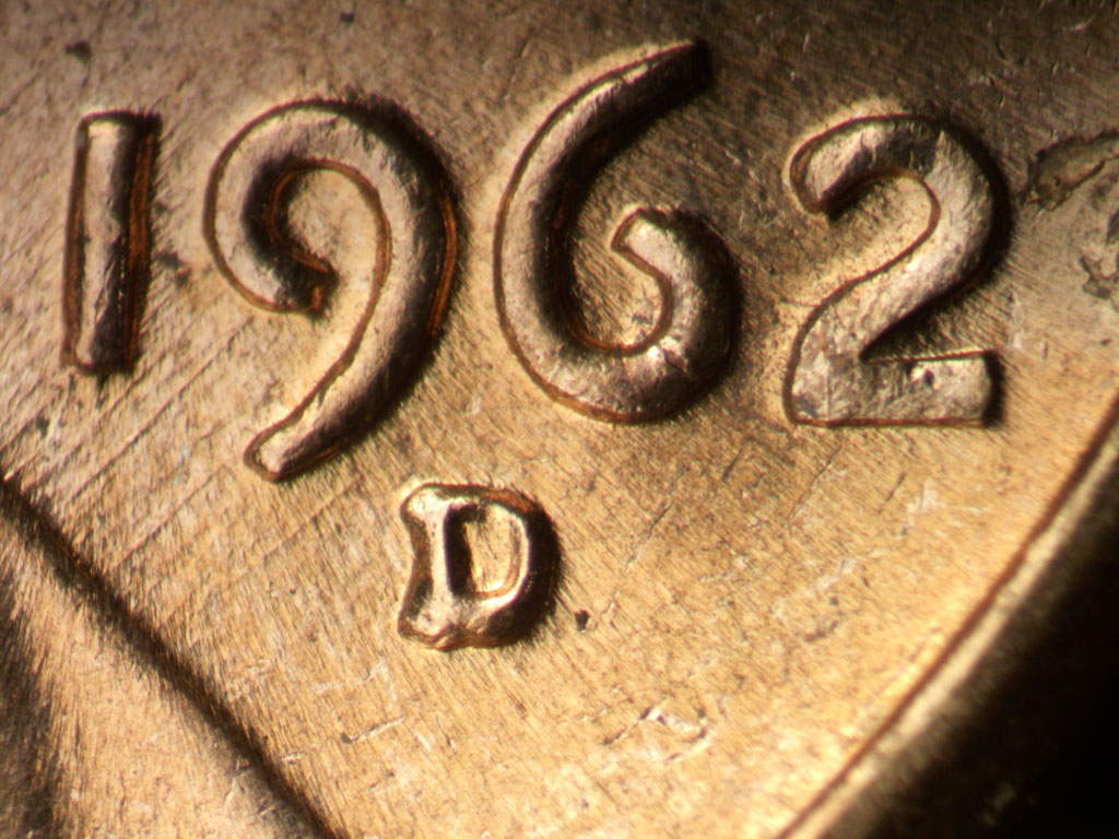 Die-stage B marker on 1962D•1MM•038 showing NE die scratches through 19 in date.