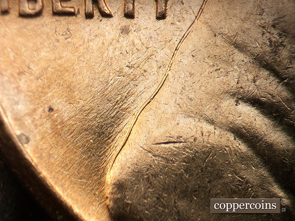 Die-stage B marker on 1962D•1MM•038 showing SW die scratches from back of shoulder.