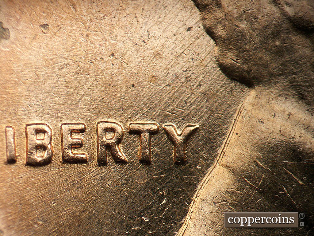 Die-stage B marker on 1962D•1MM•038 showing SW die scratches through RTY in LIBERTY.