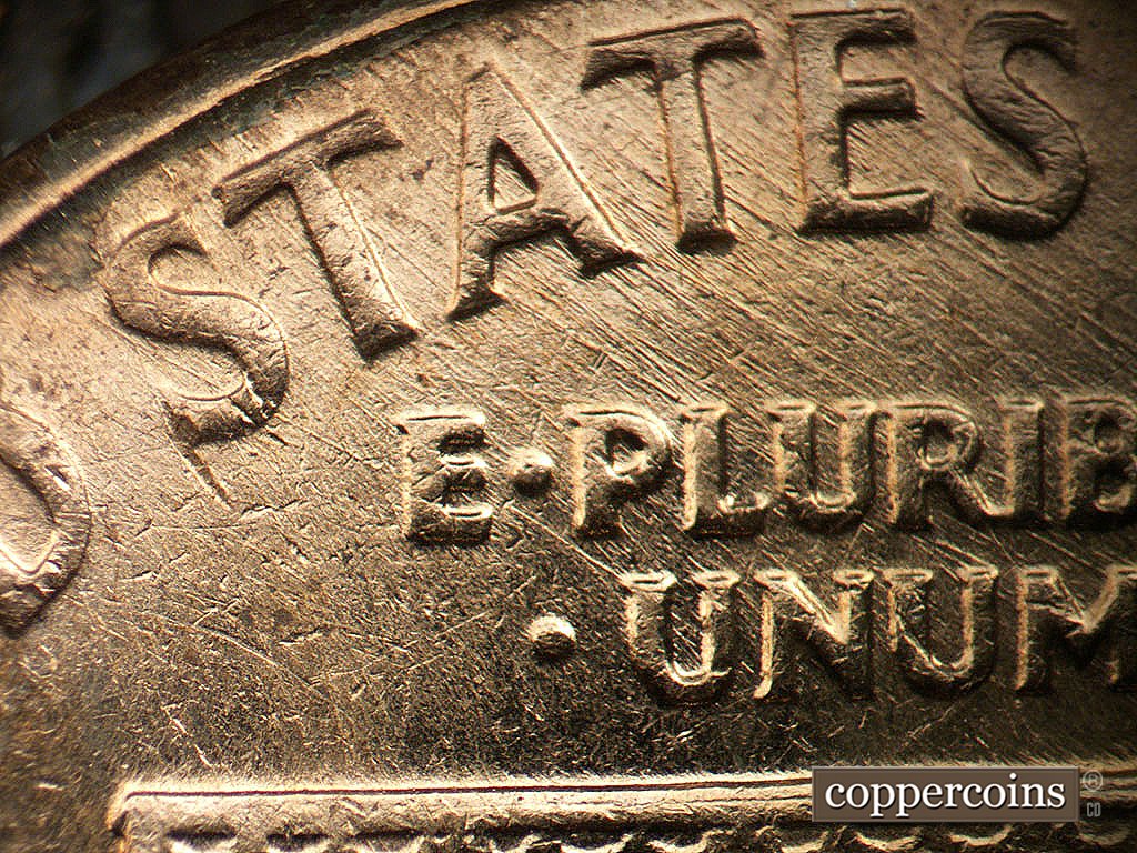 Die-stage B marker on 1962D•1MM•038 showing NW/SE die scratches through STATES and EPU.