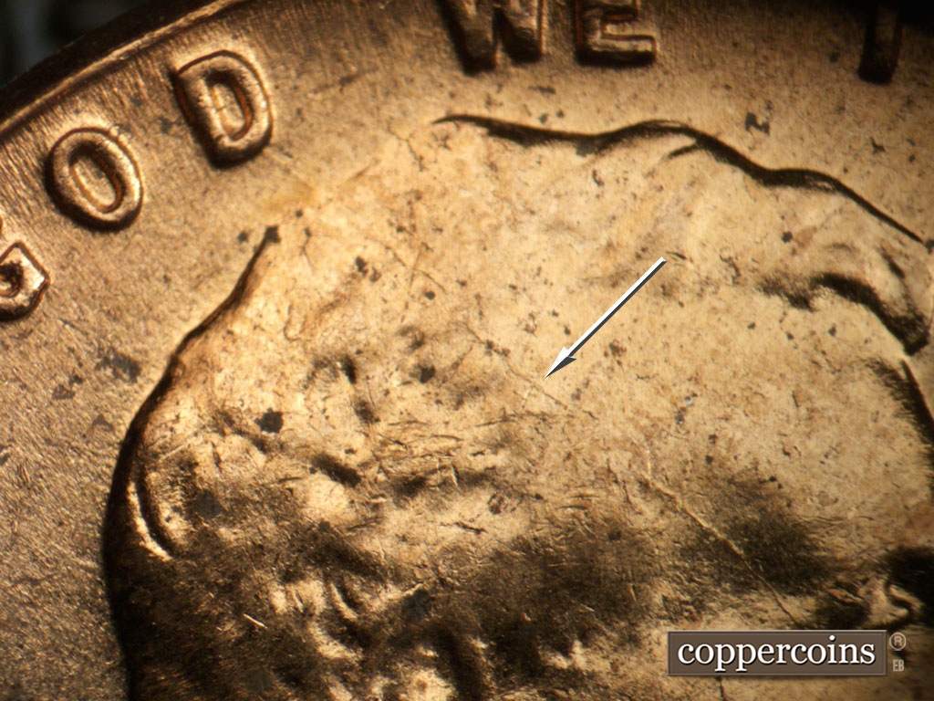 Die-stage C marker on 1963D•1DR•007 showing SE die crack from D in GOD through Head.
