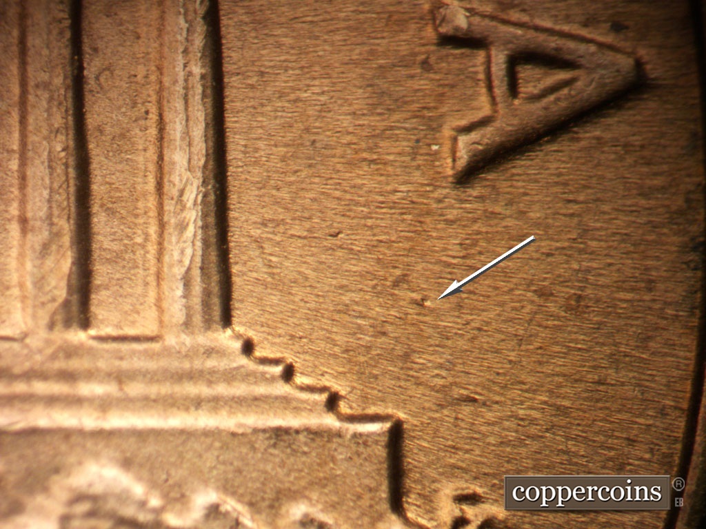 Die-stage B marker on 1963P•1DO•039 showing Die dot in field under last A in AMERICA.