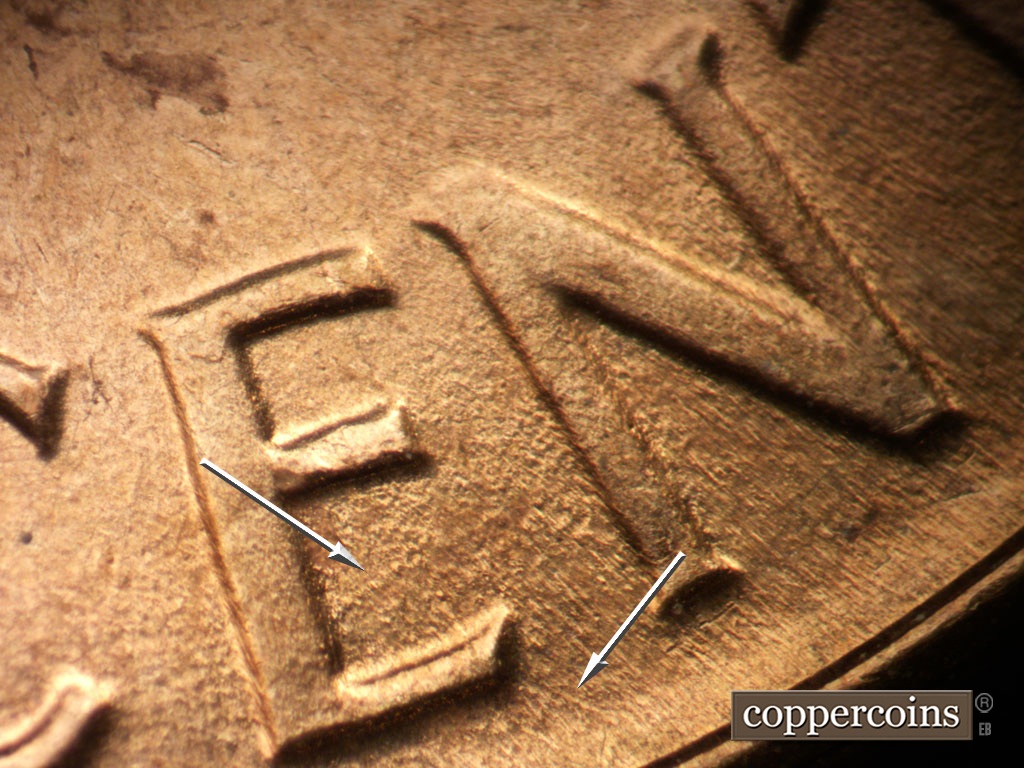 Die-stage B marker on 1963P•1DO•039 showing Worn ENE die scratch in lower E of CENT. SE die scratch from bottom of E in CET to rim.