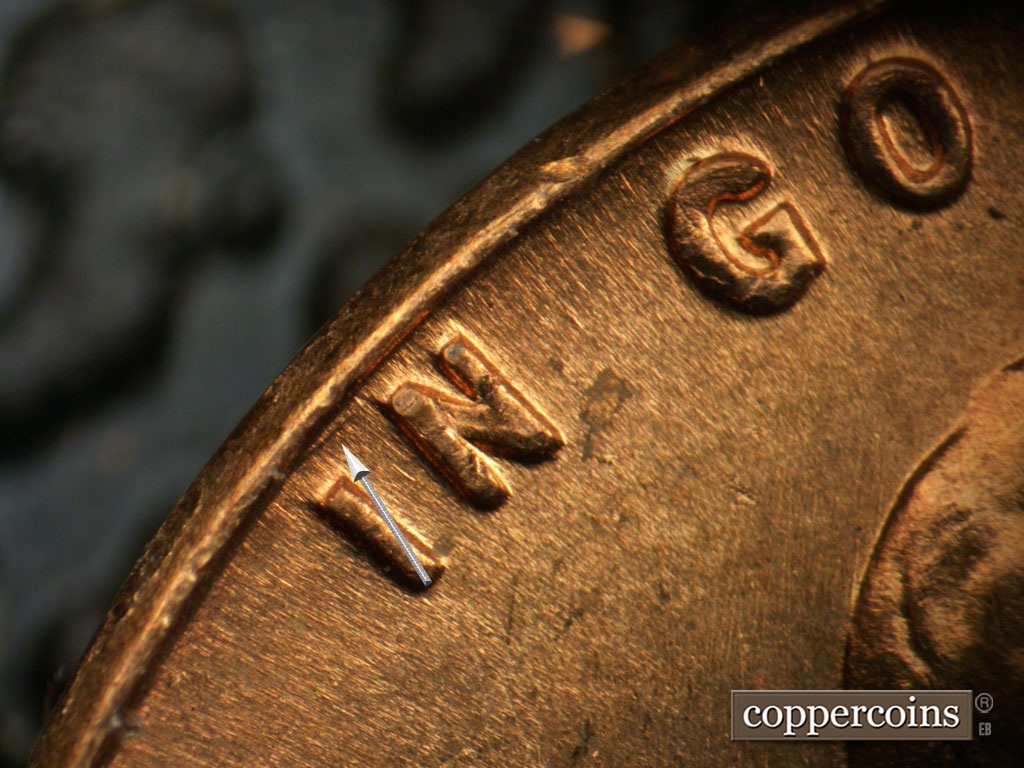 Die-stage B marker on 1963P•1DO•042 showing Small die gouge between rim and IN.