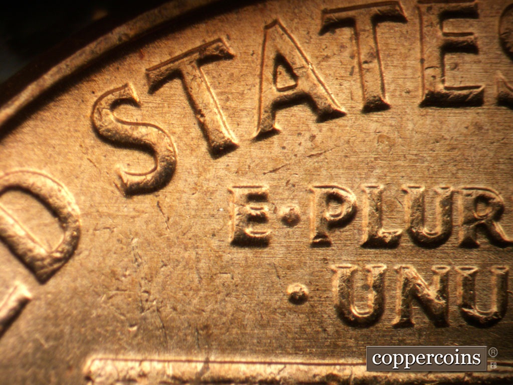 Die-stage B marker on 1963P•1DO•042 showing Light E/W die scratching through STATES and E PLURIBUS UNUM.
