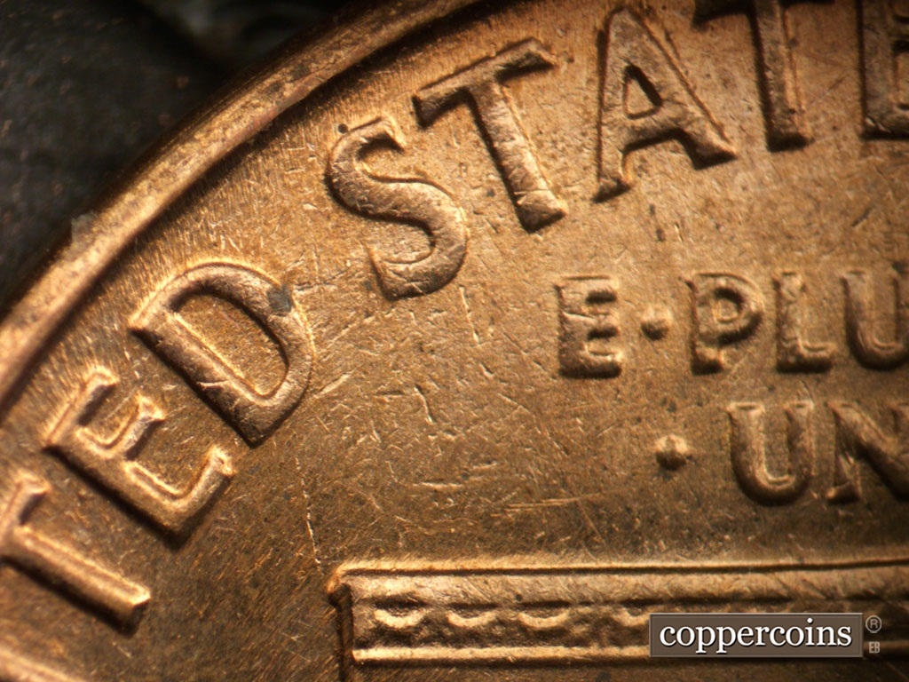 Die-stage B marker on 1964D•1DR•018 showing Upper left of reverse.
