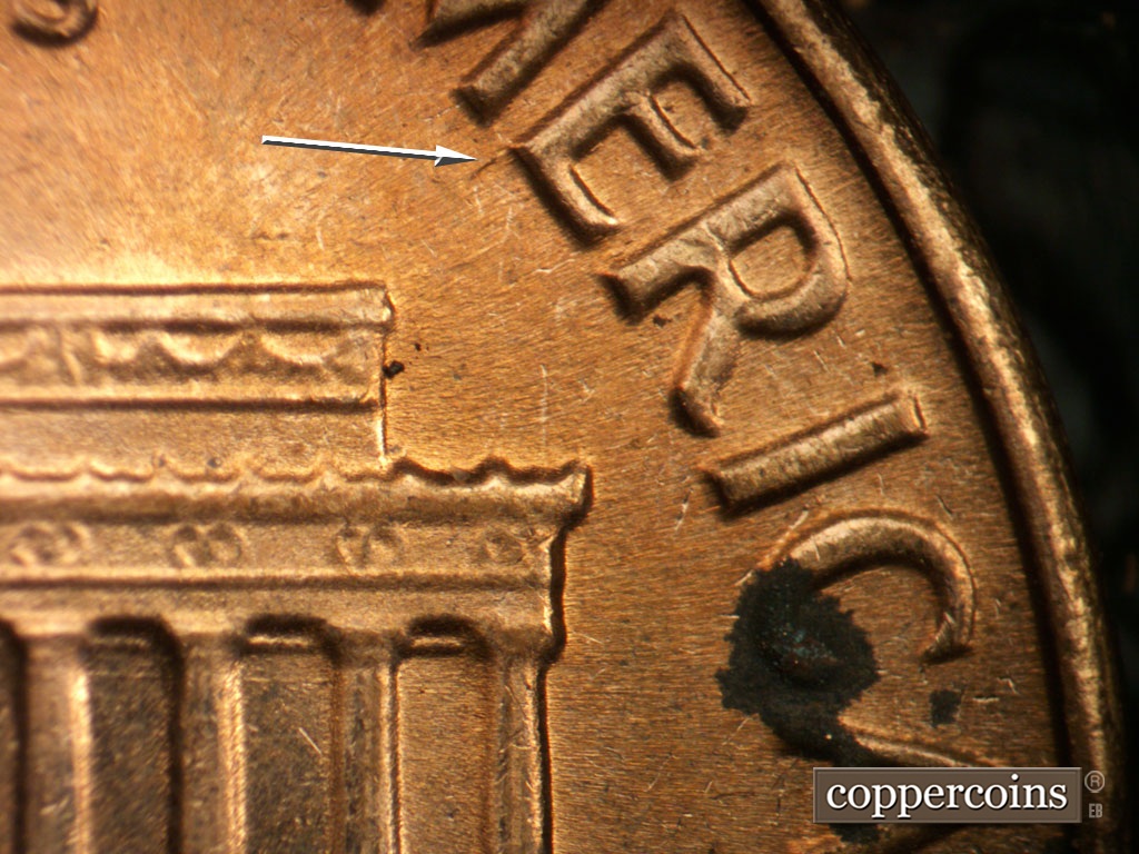 Die-stage B marker on 1964D•1DR•018 showing Die gouge or crack from E in AMERICA.