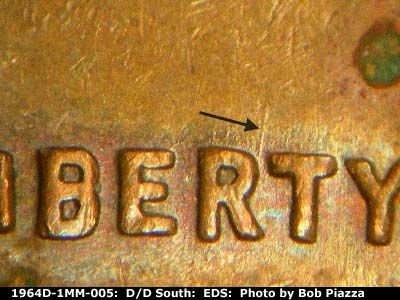 Die-stage A marker on 1964D•1MM•005 showing A strong die scratch runs north from the R in LIBERTY.