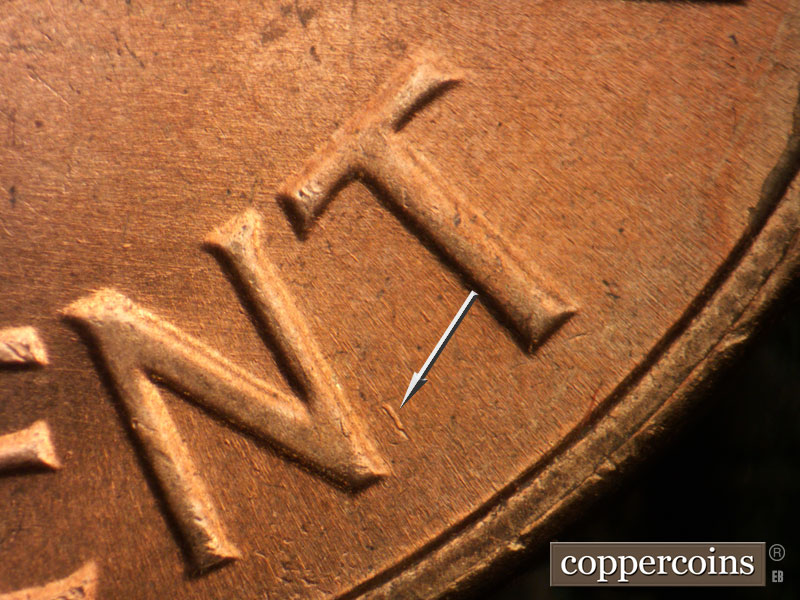 Die-stage B marker on 1964D•1MM•005 showing Die gouge between NT of CENT.