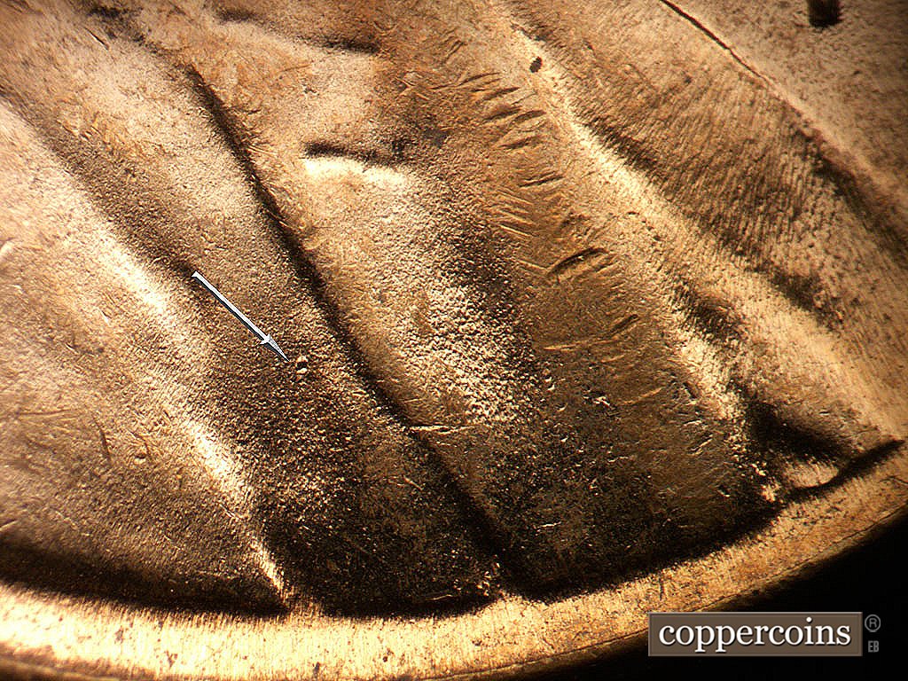 Die-stage C marker on 1964D•1MM•005 showing Die dot on jacket.
