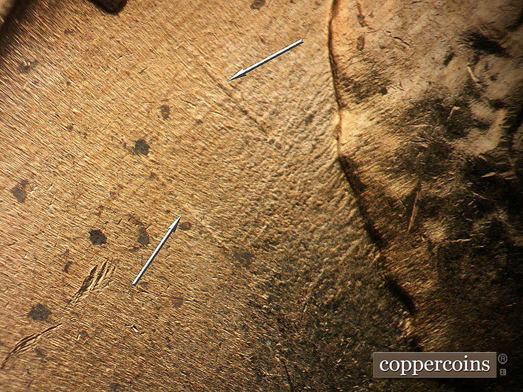 Die-stage B marker on 1964D•1MM•040 showing NE die gouges behind head.