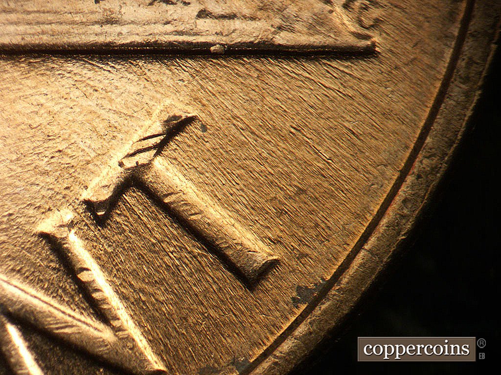 Die-stage B marker on 1964D•1MM•040 showing Die scratches through CENT.